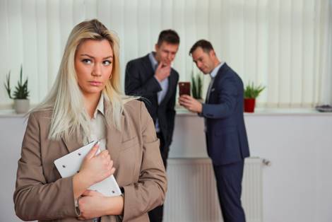 Men taking inappropriate photo of female coworker - Sexual Discrimination